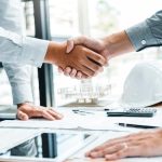 Engineer handshake meeting for architectural project and working
